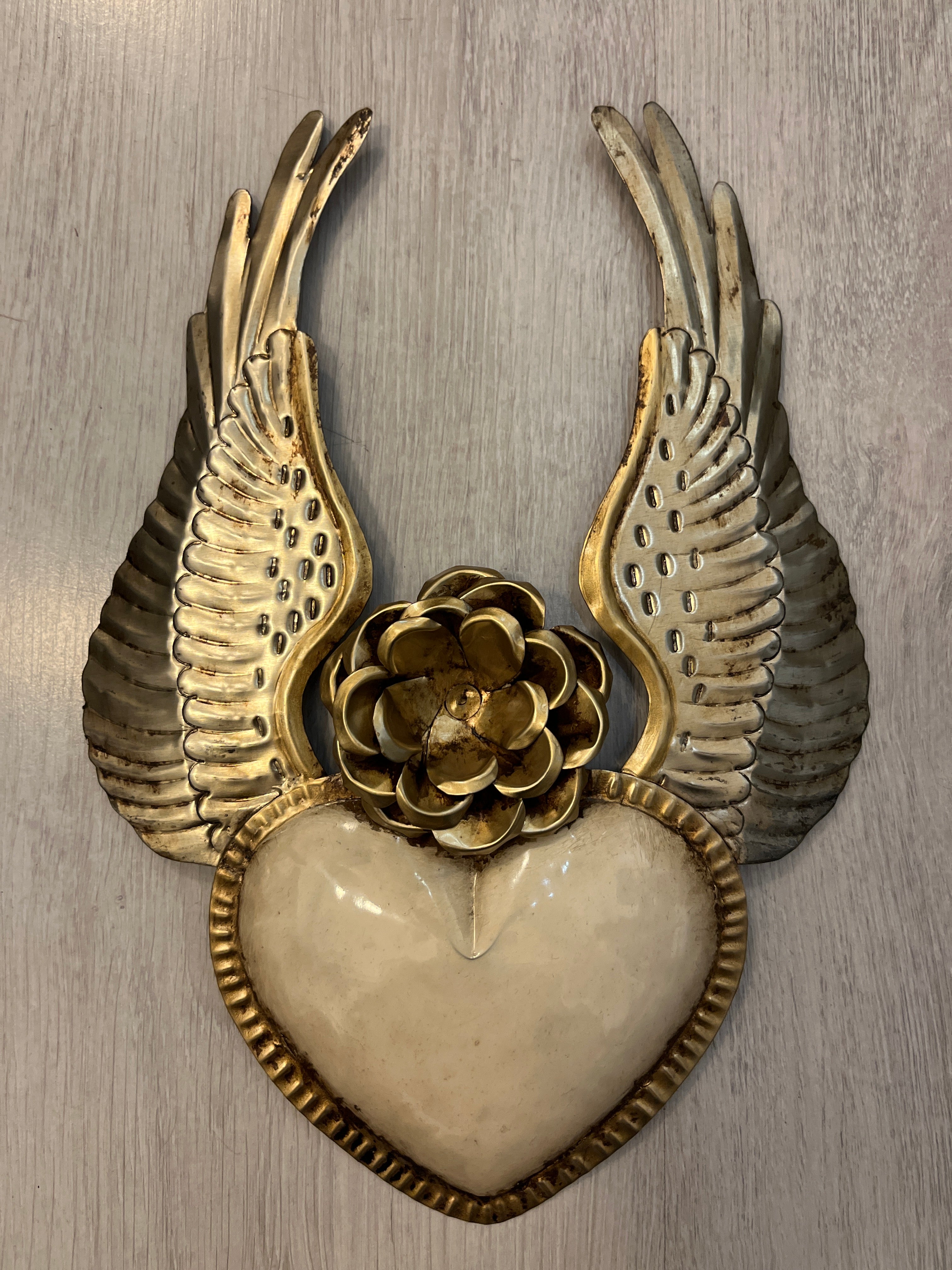 Corazón alado con una flor