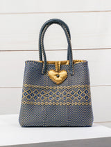 Bolsa artesanal corazón milagro mediana con pompón de flor